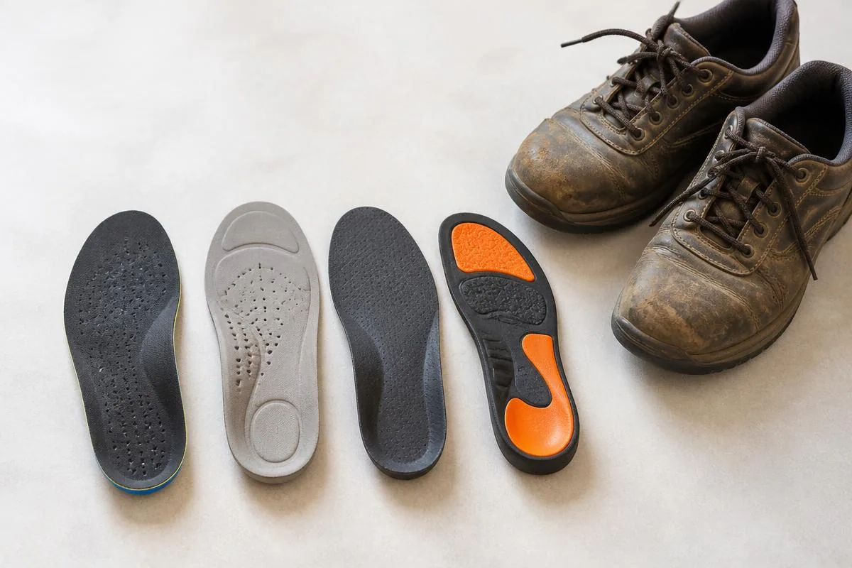 IMAGE — insoles beside work shoes